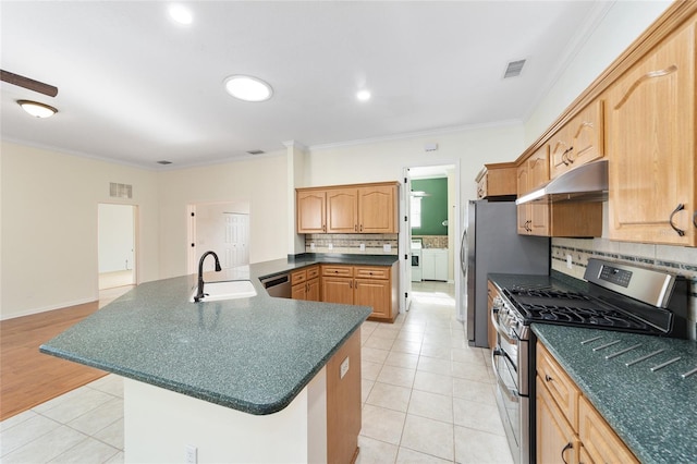 kitchen with washer and clothes dryer, crown molding, sink, and appliances with stainless steel finishes