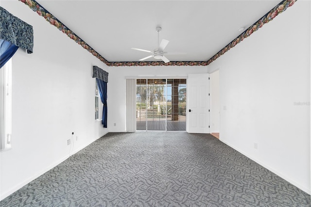 carpeted spare room with ceiling fan