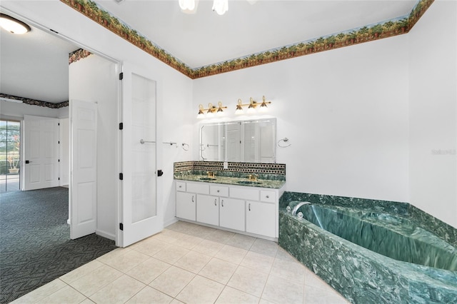 bathroom with a bath, vanity, and tile patterned floors