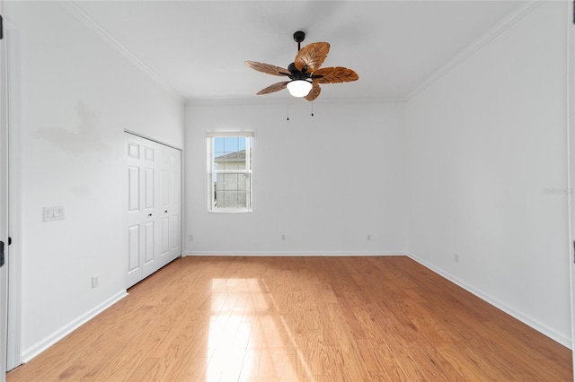 spare room featuring ceiling fan, ornamental molding, and light hardwood / wood-style flooring