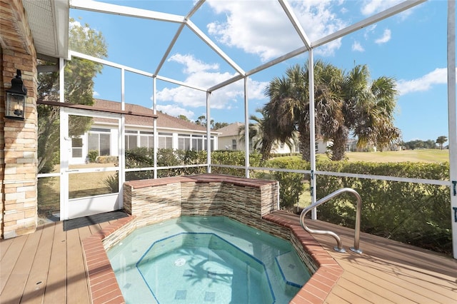 view of swimming pool with an outdoor hot tub and glass enclosure