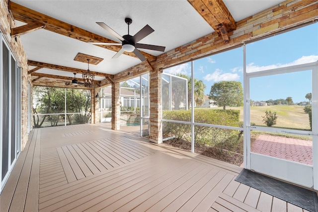 sunroom / solarium featuring beam ceiling and ceiling fan