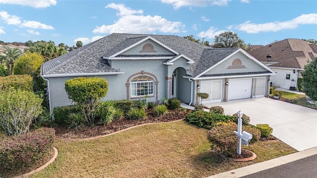 view of front of property with a garage and a front lawn