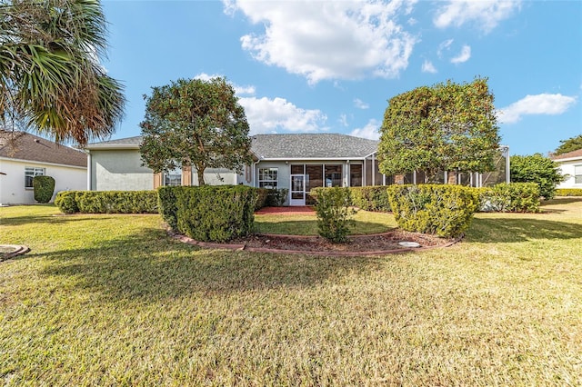 ranch-style house with a sunroom and a front lawn