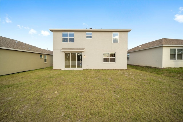 rear view of house with a lawn