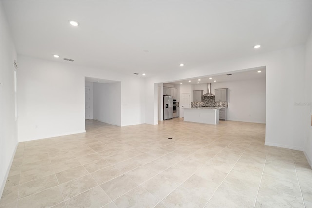 unfurnished living room featuring light tile patterned floors