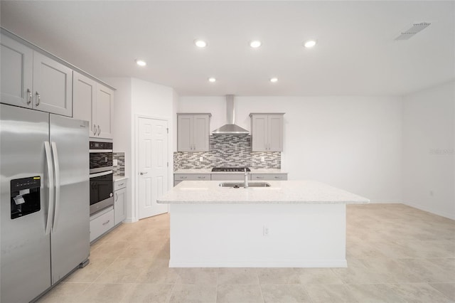 kitchen with a center island with sink, wall chimney exhaust hood, sink, and stainless steel refrigerator with ice dispenser