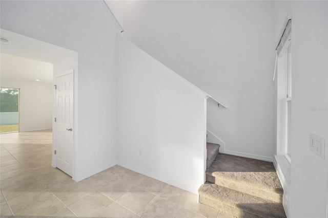 staircase featuring tile patterned flooring