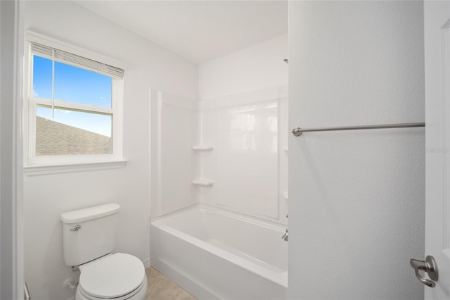 bathroom featuring shower / bathtub combination and toilet