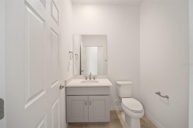 bathroom featuring tile patterned flooring, vanity, and toilet