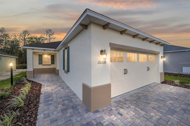 property exterior at dusk with a garage