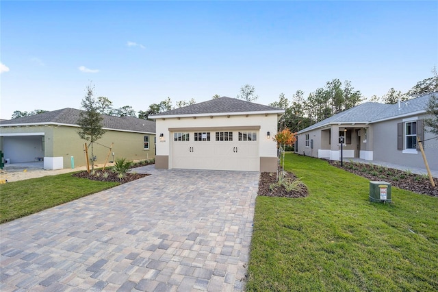 view of front of property featuring a garage and a front lawn