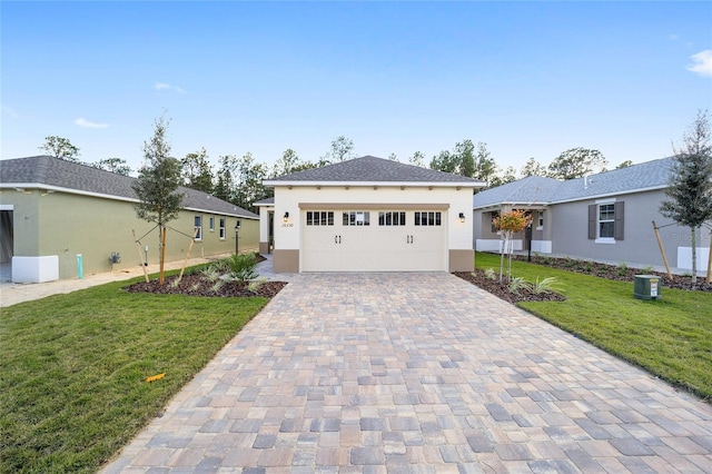 view of front of property featuring a front yard and a garage