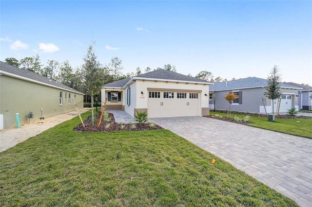 view of front of property with a front yard and a garage