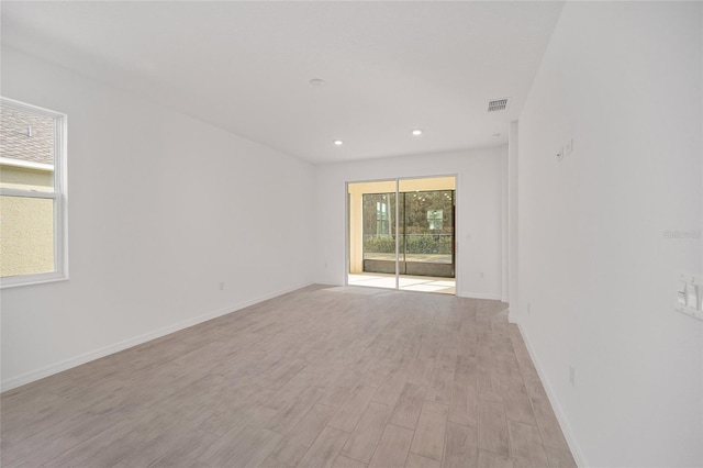 empty room with light hardwood / wood-style flooring