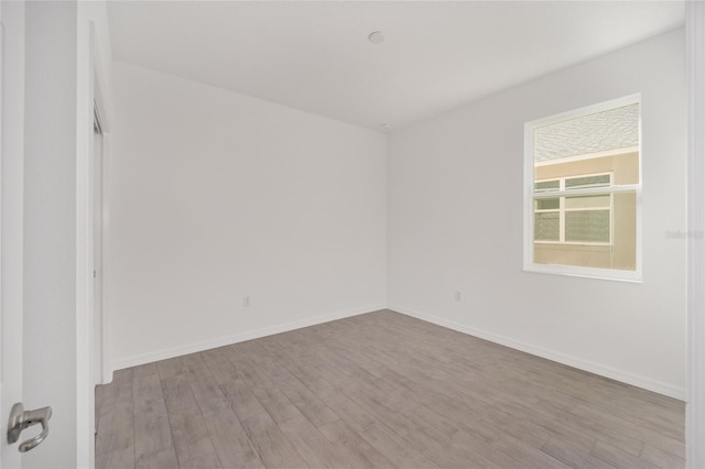 unfurnished room with light hardwood / wood-style flooring