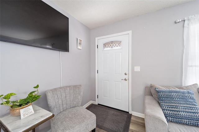 foyer entrance with a textured ceiling and hardwood / wood-style flooring