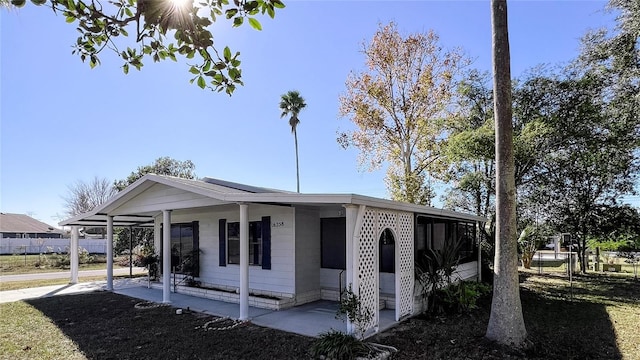 view of front facade with a carport and a front yard