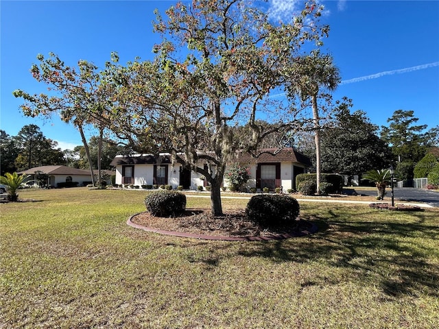 mediterranean / spanish house with a front lawn