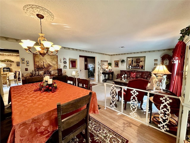 dining area with a notable chandelier and wood-type flooring