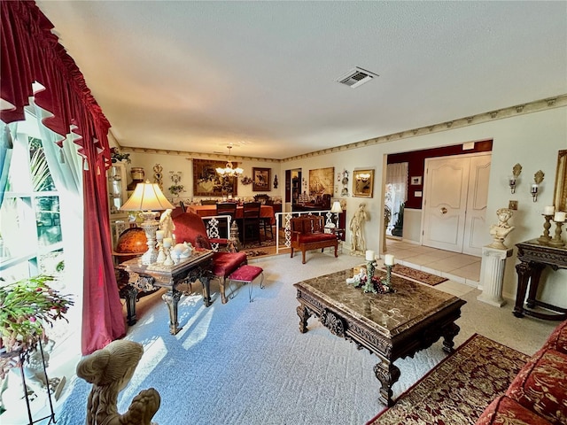 carpeted living room featuring an inviting chandelier