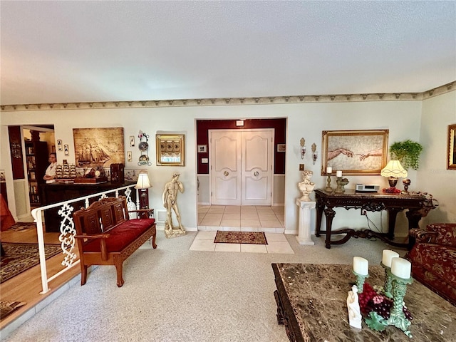 foyer with light carpet and a textured ceiling