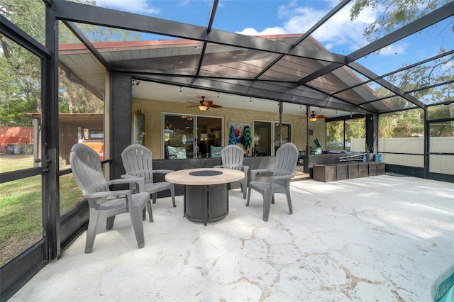 sunroom with ceiling fan and lofted ceiling