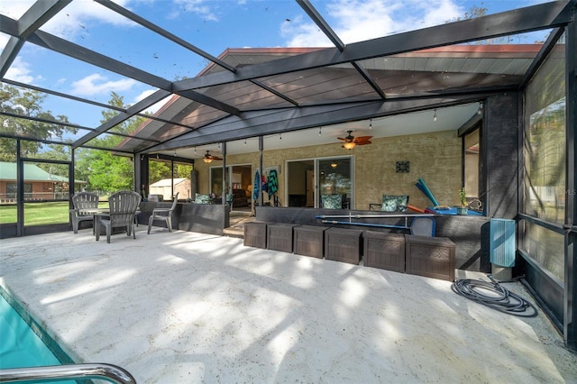 view of patio / terrace featuring ceiling fan and a lanai