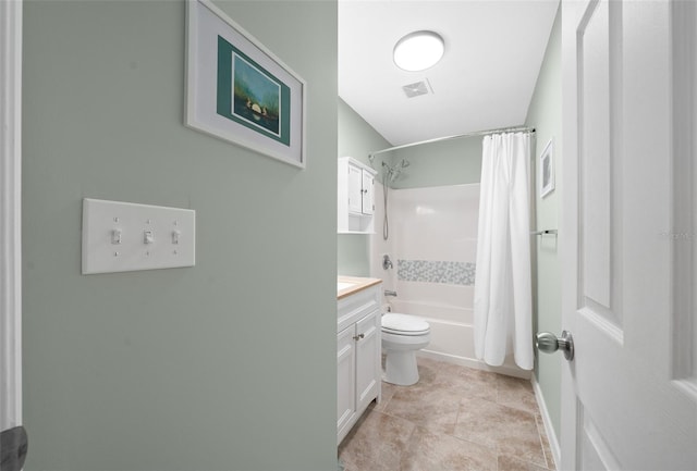 full bathroom with tile patterned floors, shower / bath combo with shower curtain, vanity, and toilet