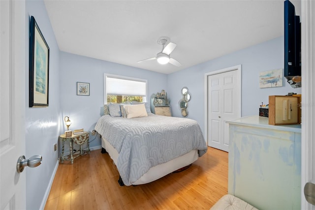 bedroom with a closet, ceiling fan, and hardwood / wood-style floors