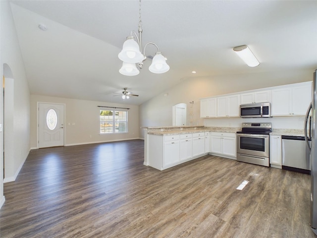 kitchen featuring lofted ceiling, hanging light fixtures, dark hardwood / wood-style flooring, white cabinetry, and stainless steel appliances