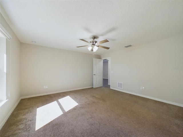 spare room featuring carpet flooring and ceiling fan