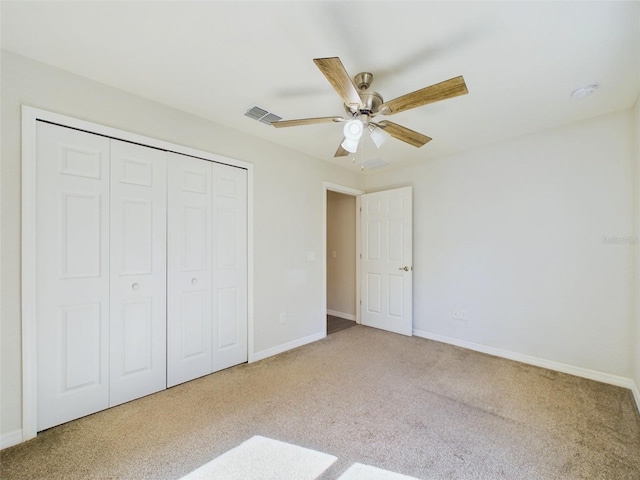 unfurnished bedroom featuring carpet flooring, ceiling fan, and a closet