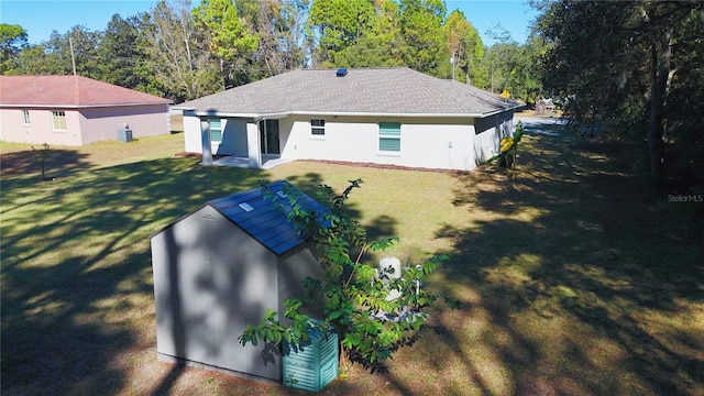 rear view of property featuring a yard