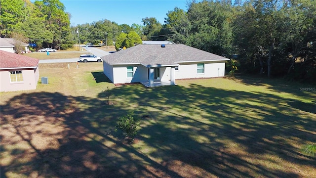 rear view of property featuring a yard