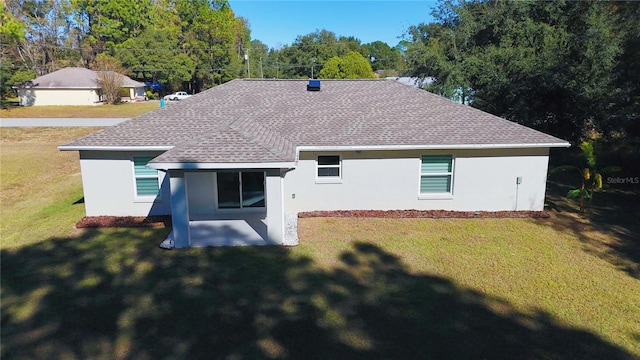 rear view of house with a yard and a patio area