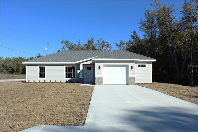 ranch-style home featuring a garage and a front yard