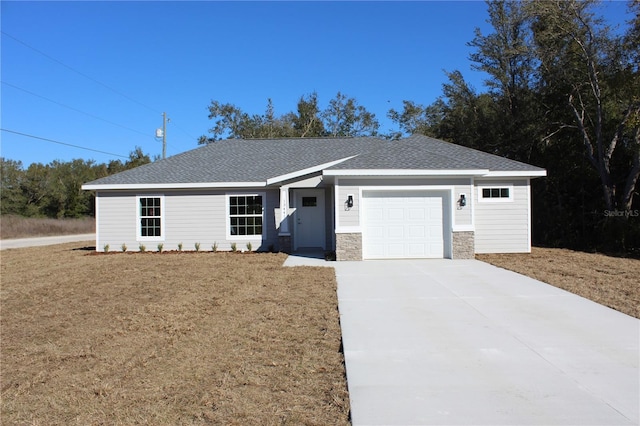 ranch-style house featuring a garage and a front yard