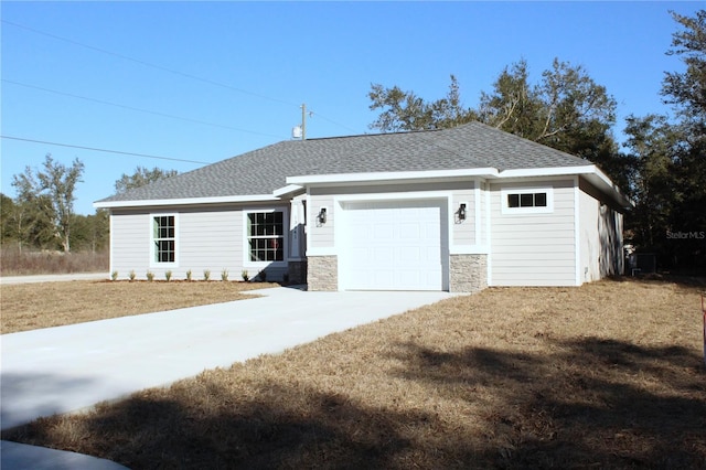 view of front of property with a garage and a front lawn