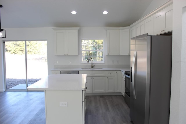 kitchen featuring sink, white cabinetry, appliances with stainless steel finishes, plenty of natural light, and a kitchen island