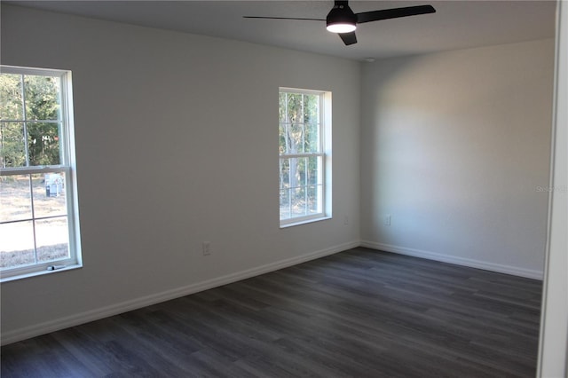 unfurnished room featuring ceiling fan, a healthy amount of sunlight, and dark hardwood / wood-style flooring