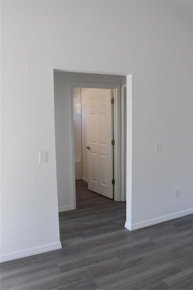 hallway featuring dark hardwood / wood-style flooring