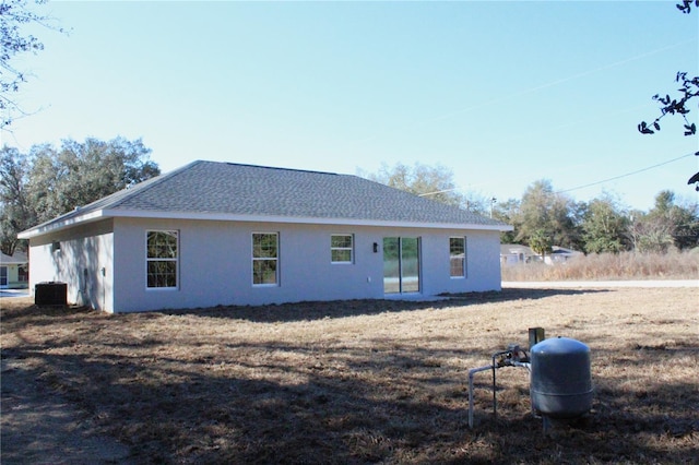 rear view of property featuring central AC