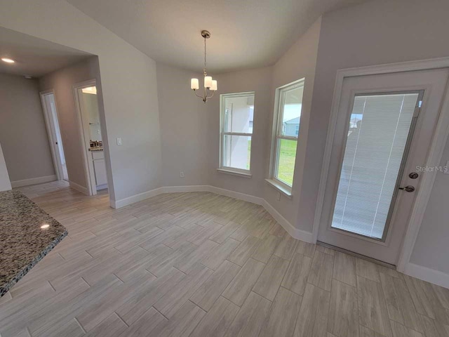 unfurnished dining area with a chandelier