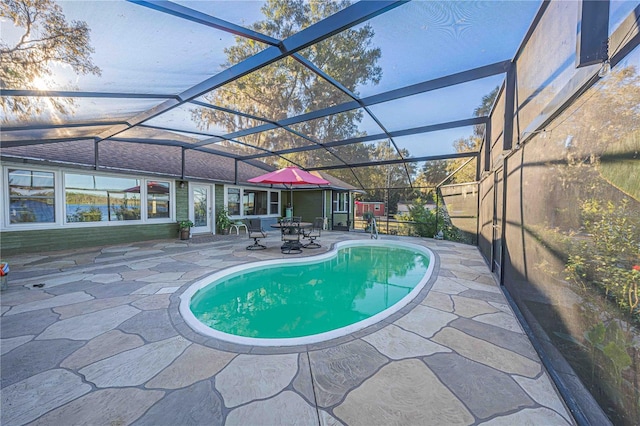 view of pool featuring a lanai and a patio