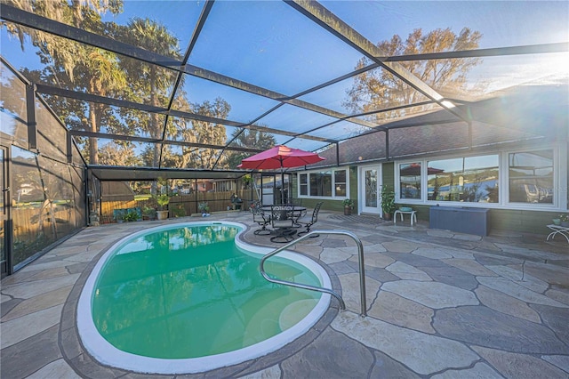 view of pool featuring a patio area and glass enclosure