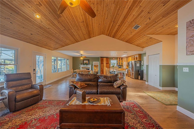 living room featuring light hardwood / wood-style flooring, vaulted ceiling, ceiling fan, and wooden ceiling