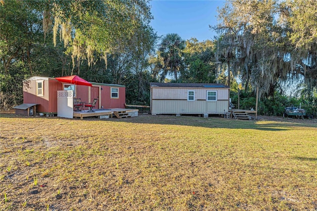 view of yard with a shed and a wooden deck