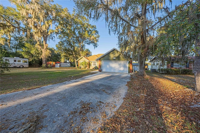 view of front of house featuring a garage and a front lawn