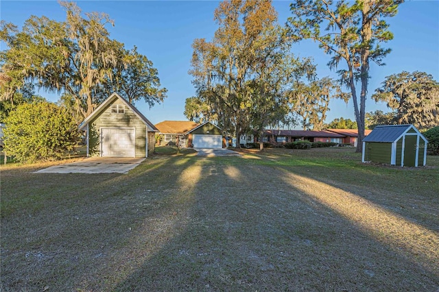 view of front of house with a garage, a front yard, and a storage unit